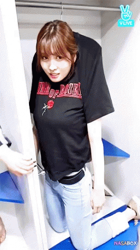 a woman in a black shirt that says king of roses