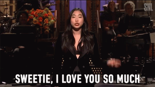 A Woman In A Black Suit Says Sweetie I Love You So Much In Front Of A Band GIF