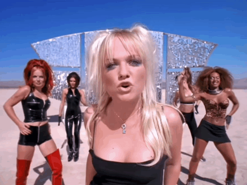 A Woman In A Black Top Has A Key Necklace GIF