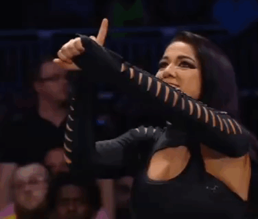 A Woman In A Black Top Is Giving A Thumbs Up Sign . GIF