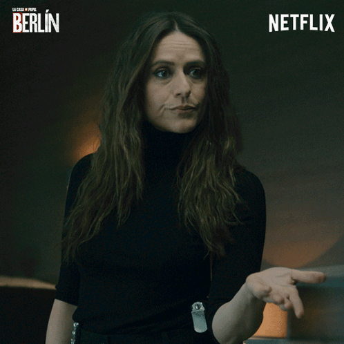 Woman In Black Turtleneck Next To Netflix Logo GIF
