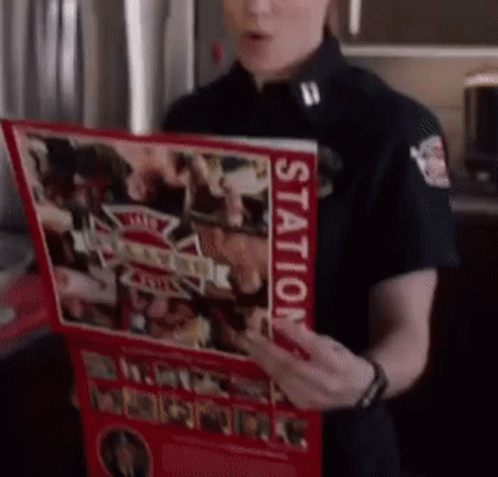 A Woman In A Black Uniform Is Holding A Red Book That Says Station On It GIF
