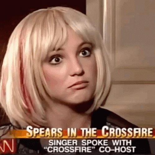 A Woman In A Blonde Wig Is Talking On A News Channel . GIF