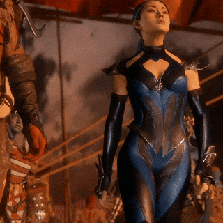 A Woman In A Blue And Black Costume Holds A Sword In Her Hand GIF