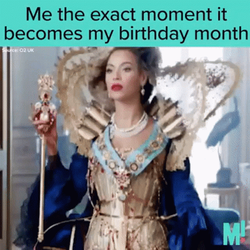 A Woman In A Blue And Gold Dress Is Holding A Crown GIF