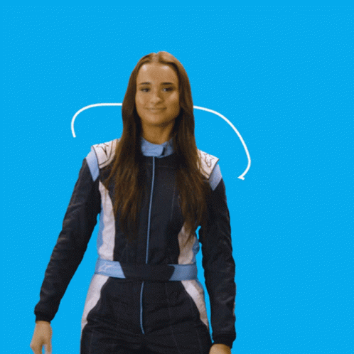 A Woman In A Blue And White Jumpsuit Is Smiling GIF