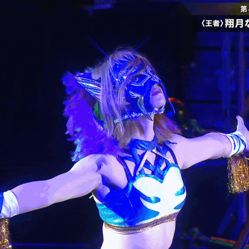 A Woman In A Blue And White Outfit With A Mask On Her Head GIF
