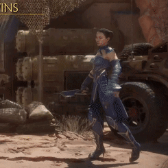 A Woman In A Blue Armor Stands In Front Of A Jeep GIF