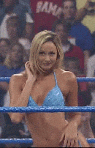 A Woman In A Blue Bikini Is Standing In A Ring With Her Hands On Her Hips GIF