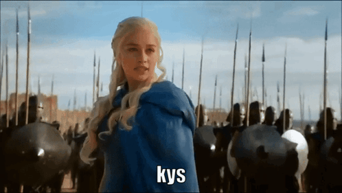 A Woman In A Blue Cape Is Standing In Front Of A Crowd Of Soldiers And The Word Kys Is On The Bottom GIF