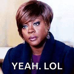 A Woman In A Blue Coat Is Making A Funny Face And Saying `` Yeah Lol '' . GIF