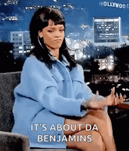 A Woman In A Blue Coat Is Sitting In A Chair With Her Hands Outstretched . GIF