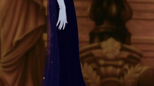 A Woman In A Blue Dress And White Gloves Stands In A Dark Room GIF