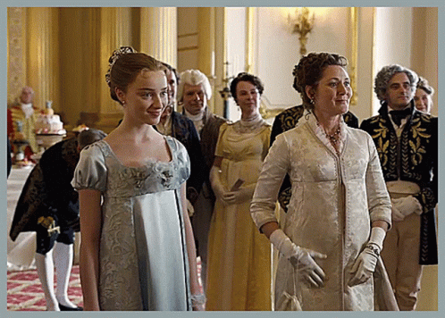 A Woman In A Blue Dress And White Gloves Stands Next To A Woman In A White Dress GIF