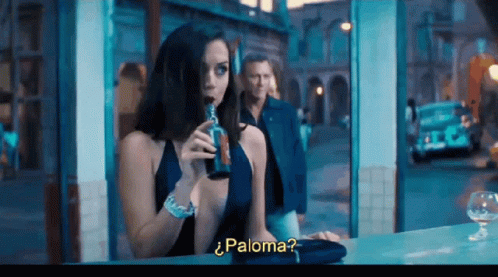 A Woman In A Blue Dress Drinking From A Bottle With The Word Paloma On The Bottom Right GIF