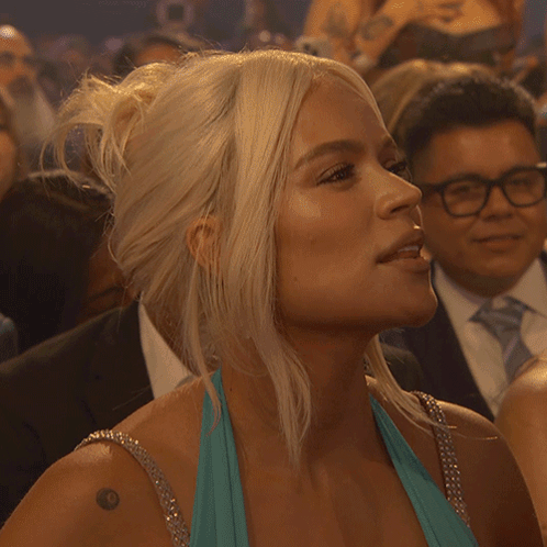 A Woman In A Blue Dress Has A Tattoo On Her Shoulder That Says ' I Love You ' GIF
