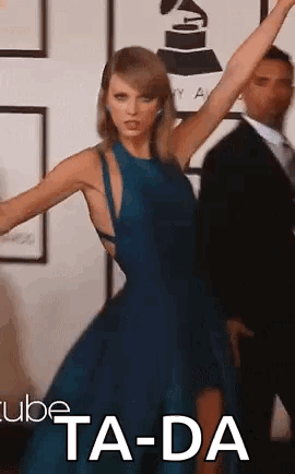 A Woman In A Blue Dress Is Dancing With Her Arms In The Air . GIF