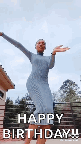 A Woman In A Blue Dress Is Dancing With Her Arms Outstretched And Saying Happy Birthday . GIF