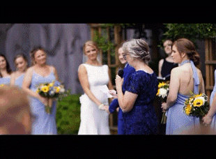 A Woman In A Blue Dress Is Giving A Speech At A Wedding GIF