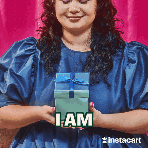 Woman In Blue Dress Holding Gift Box I Am GIF