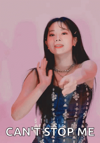 A Woman In A Blue Dress Is Pointing At The Camera With The Words " Can 'T Stop Me " Written Below Her GIF