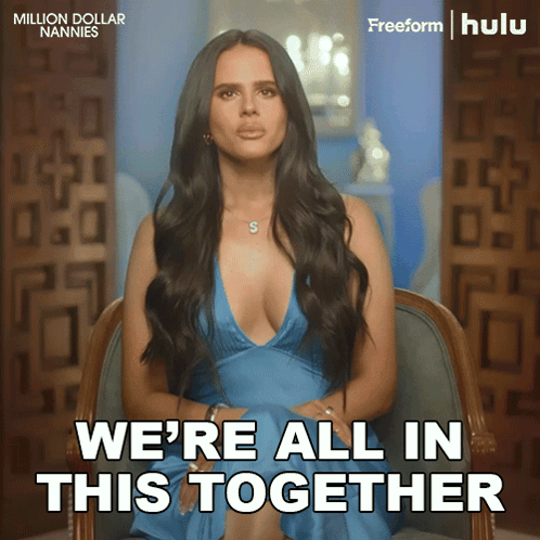 A Woman In A Blue Dress Is Sitting In A Chair With The Words We 'Re All In This Together GIF
