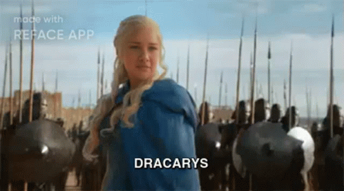 A Woman In A Blue Dress Is Standing In Front Of A Castle With A Sword In Her Hand . GIF