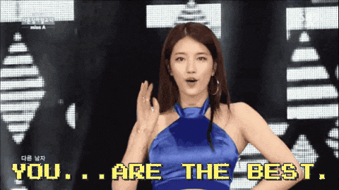 A Woman In A Blue Dress Is Standing In Front Of A Screen That Says You Are The Best GIF