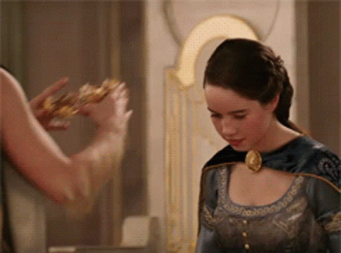 A Woman In A Blue Dress Is Standing Next To A Man Who Is Holding A Crown GIF