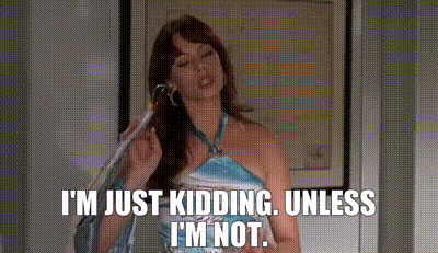 A Woman In A Blue Dress Is Talking On A Cell Phone . GIF