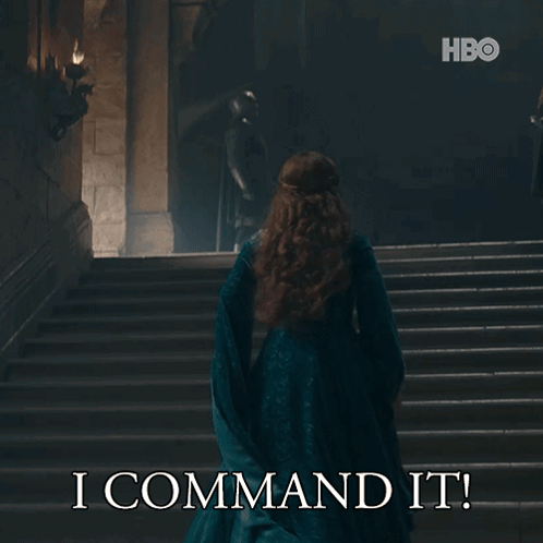 A Woman In A Blue Dress Is Walking Down A Set Of Stairs With The Words I Command It On The Bottom GIF