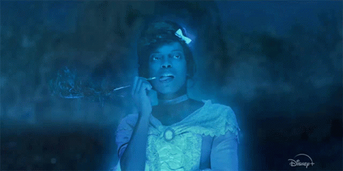 A Woman In A Blue Dress With A Disney Logo GIF