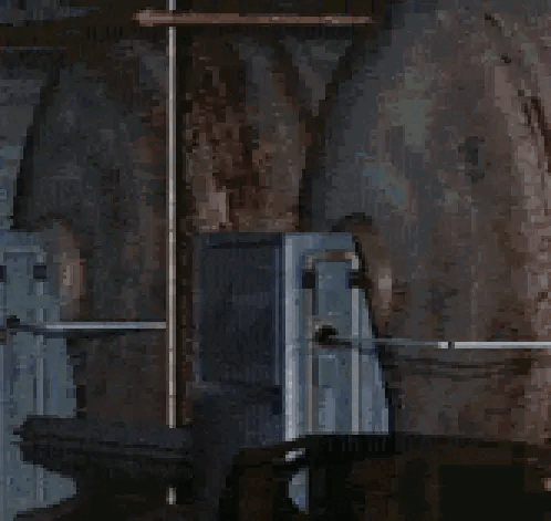 A Woman In A Blue Dress With A White Collar Is Standing In A Dark Room . GIF