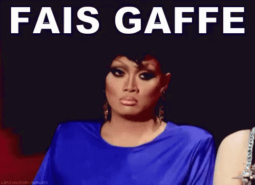 A Woman In A Blue Dress With The Words " Fais Gaffe " On Her Face GIF