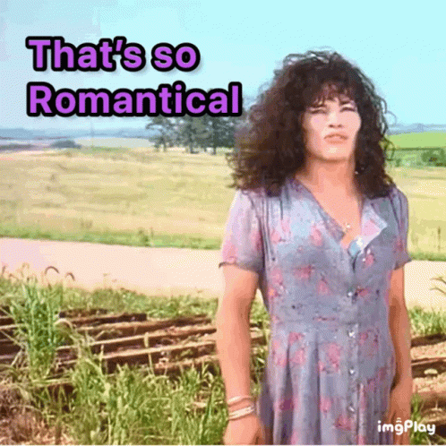 A Woman In A Blue Dress With The Words That 'S So Romantical GIF