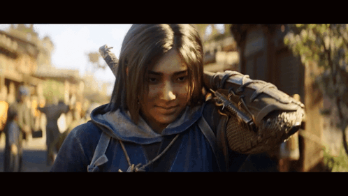 A Woman In A Blue Hoodie Is Holding A Sword On Her Shoulder GIF