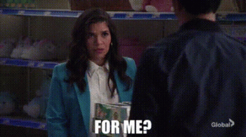 A Woman In A Blue Jacket Is Holding A Book And Asking For Me GIF
