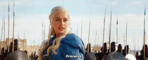 A Woman In A Blue Jacket Is Standing In Front Of A Crowd Of Soldiers And Says `` Dracarys '' . GIF