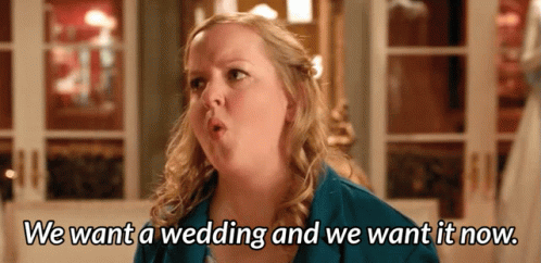 A Woman In A Blue Jacket Says We Want A Wedding And We Want It Now GIF
