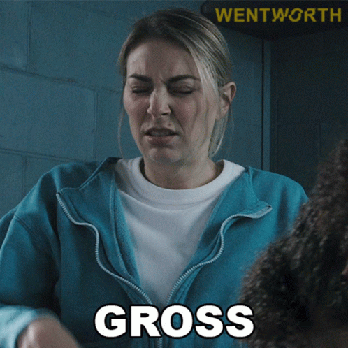 A Woman In A Blue Jacket With The Word Gross On Her Chest GIF
