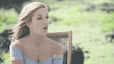 A Woman In A Blue Off The Shoulder Top Is Sitting In A Chair And Says Right GIF
