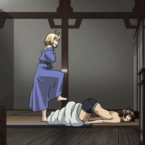 A Woman In A Blue Robe Is Standing Next To A Man Laying On A Bed GIF