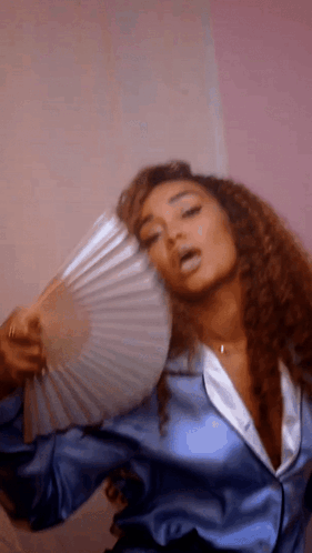 Woman In Blue Satin Jacket Holding Fan GIF