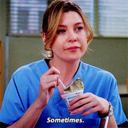A Woman In A Blue Scrub Top Is Eating Ice Cream And Says Sometimes GIF