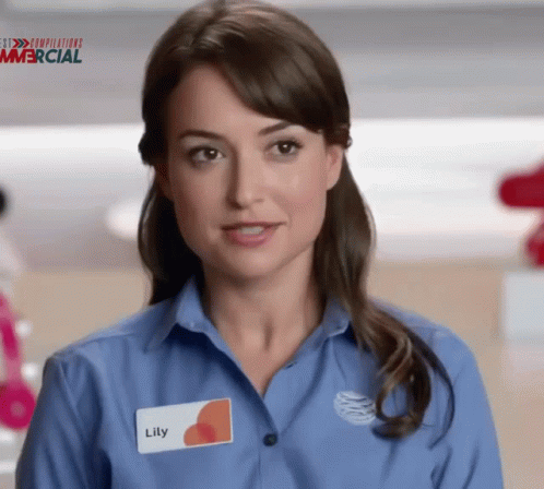 A Woman In A Blue Shirt Has A Name Tag That Says Lily GIF