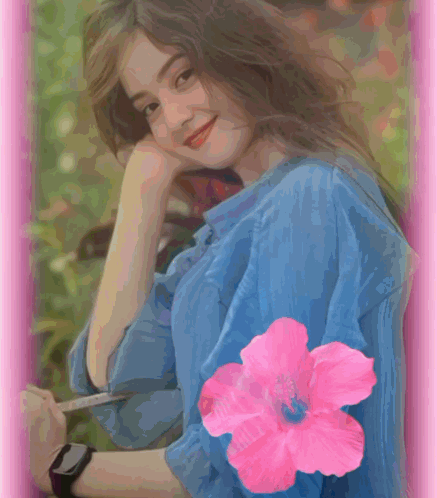 A Woman In A Blue Shirt Has A Pink Flower On Her Sleeve GIF