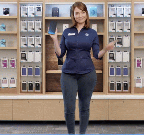 A Woman In A Blue Shirt Holds A Cell Phone GIF