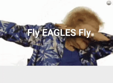 A Woman In A Blue Shirt Is Dancing And Says Fly Eagles Fly GIF