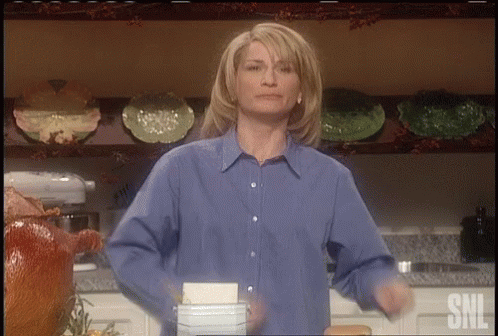 Woman In Blue Shirt Dancing In Kitchen GIF