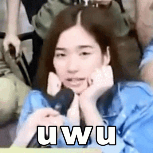 A Woman In A Blue Shirt Is Making A Funny Face With Her Hands On Her Face And The Words Uwu On The Bottom GIF